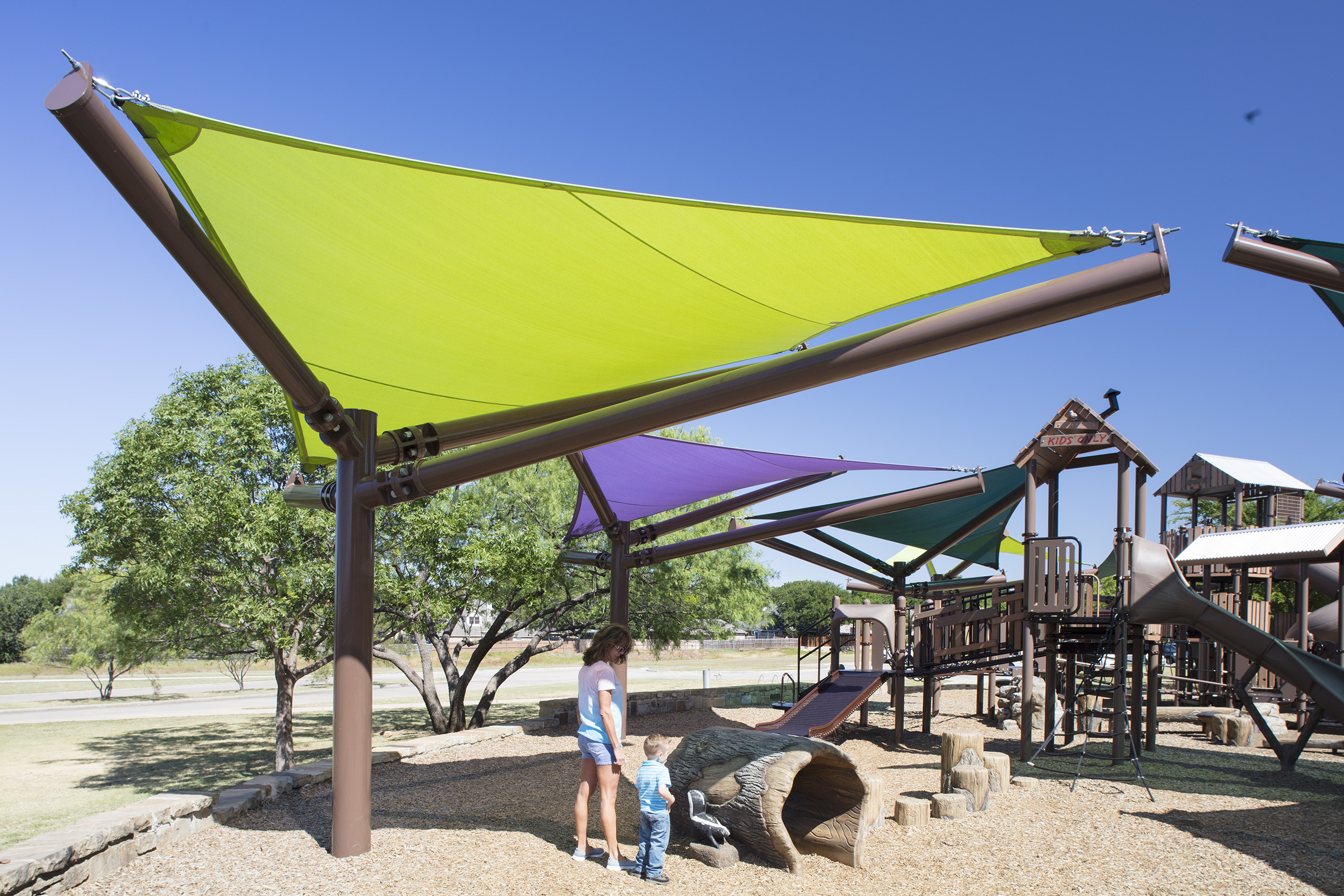 large triangle shade covering adult and child from sun