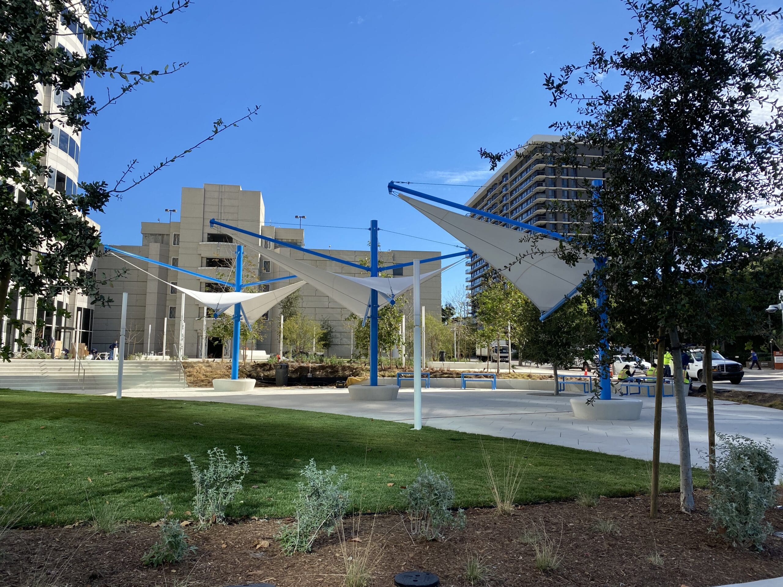 triangle shades next to grass area and trees