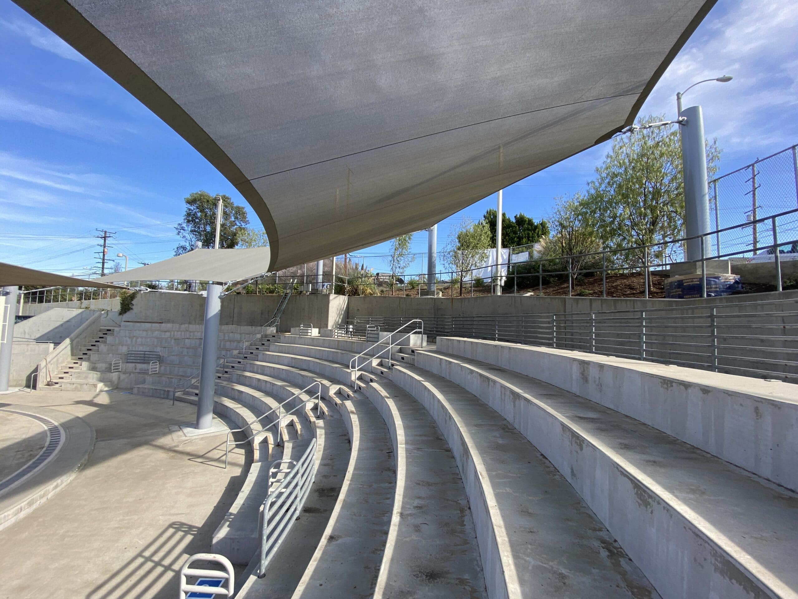concrete seating at amphitheater covered by shades