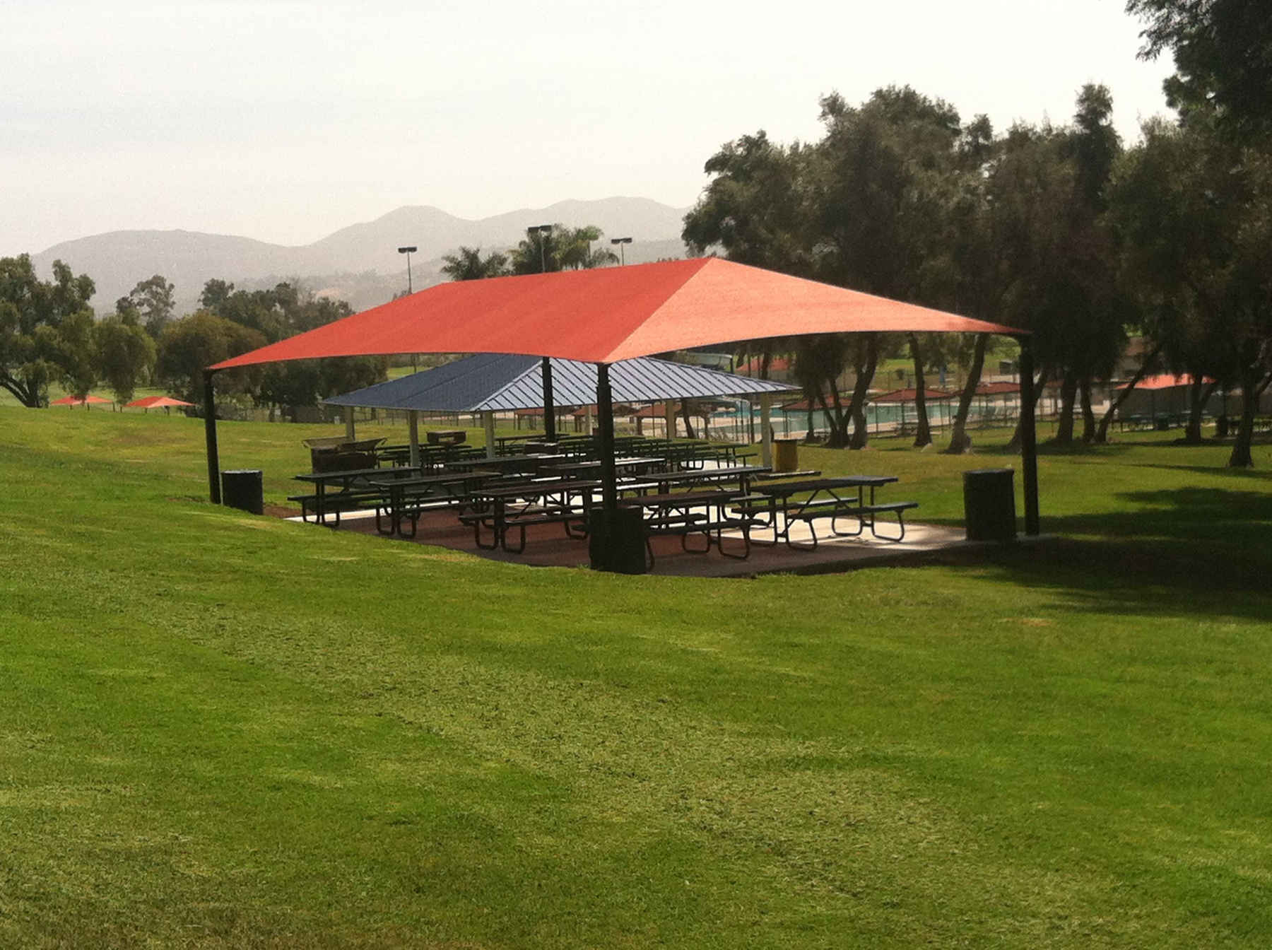 orange shade in park covering picnic tables