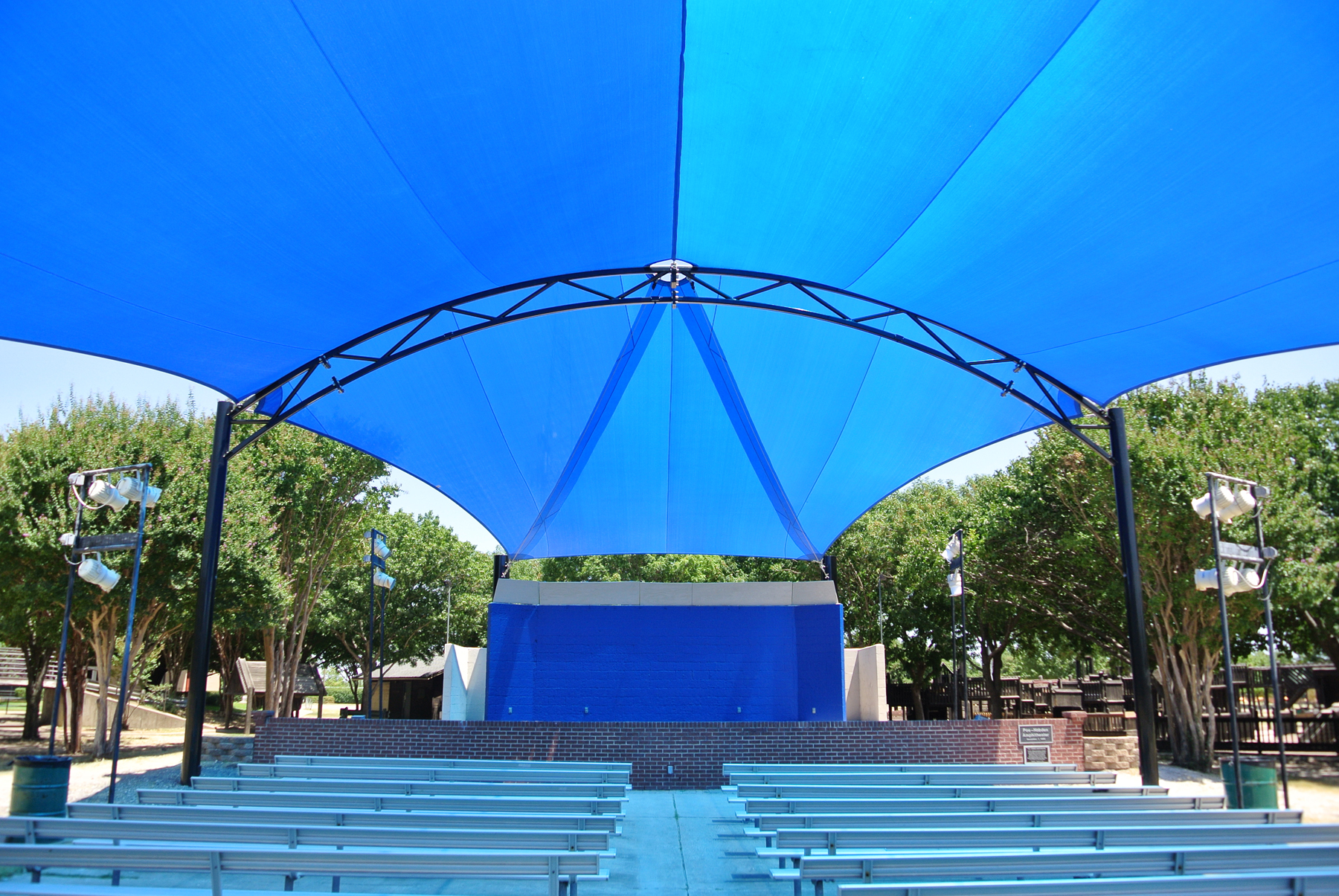 outdoor event space with blue shade cover