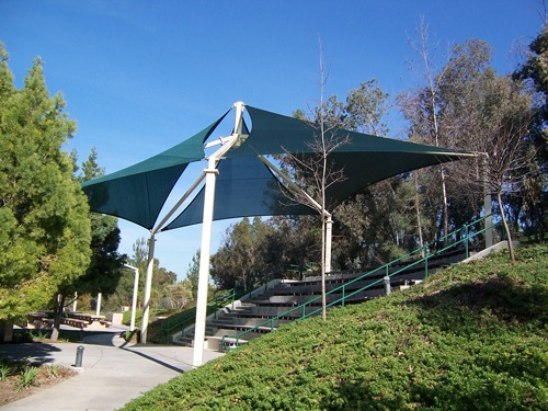 green shade in park covering seating area