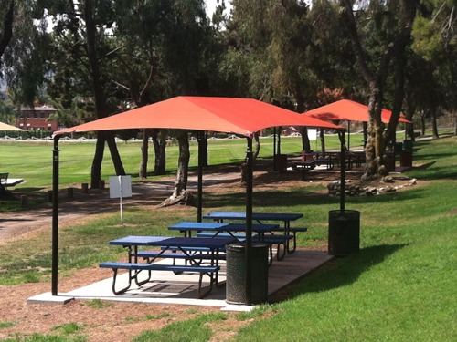 orange shades in park covering tables
