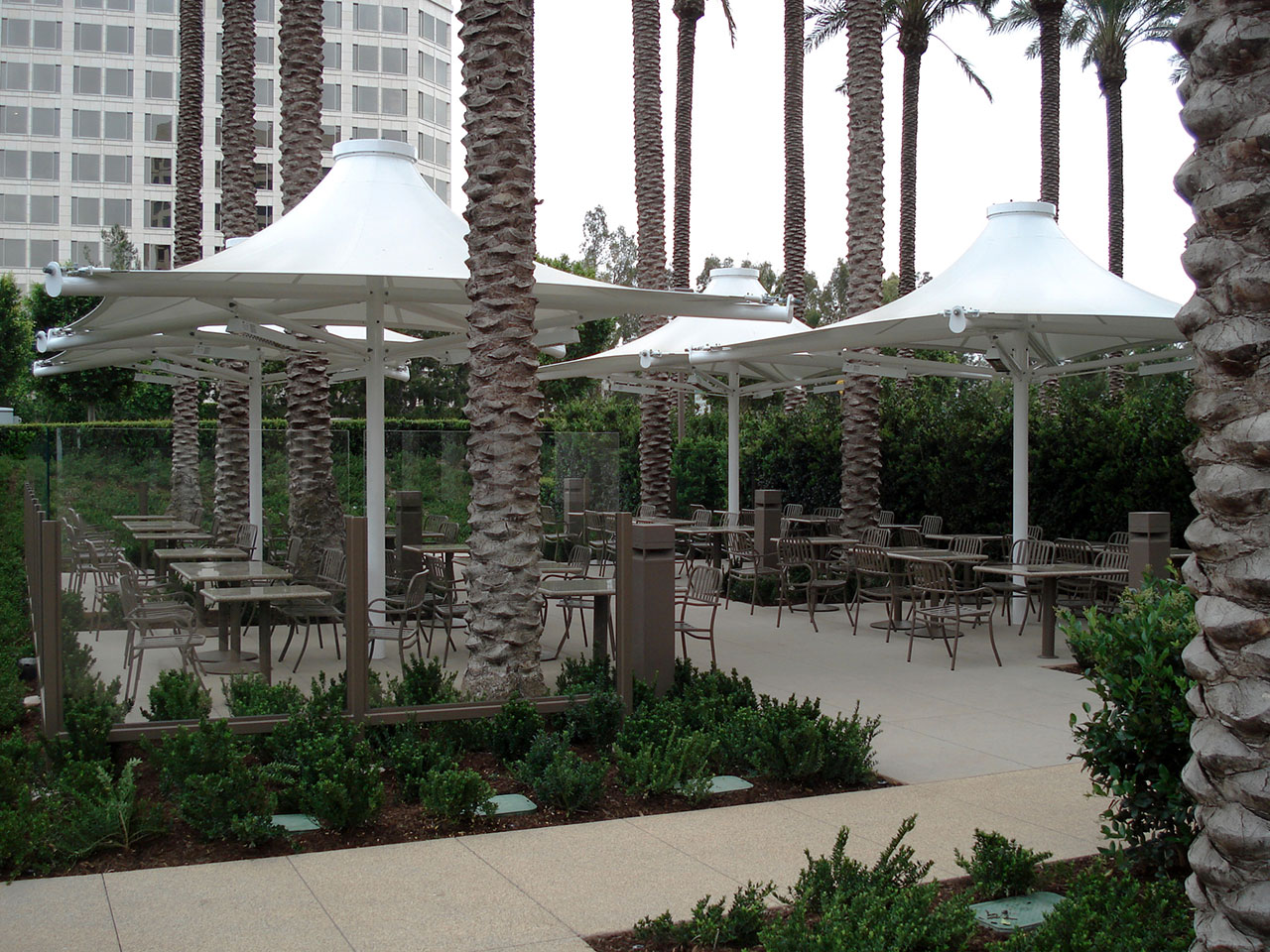 white shades covering outdoor seating