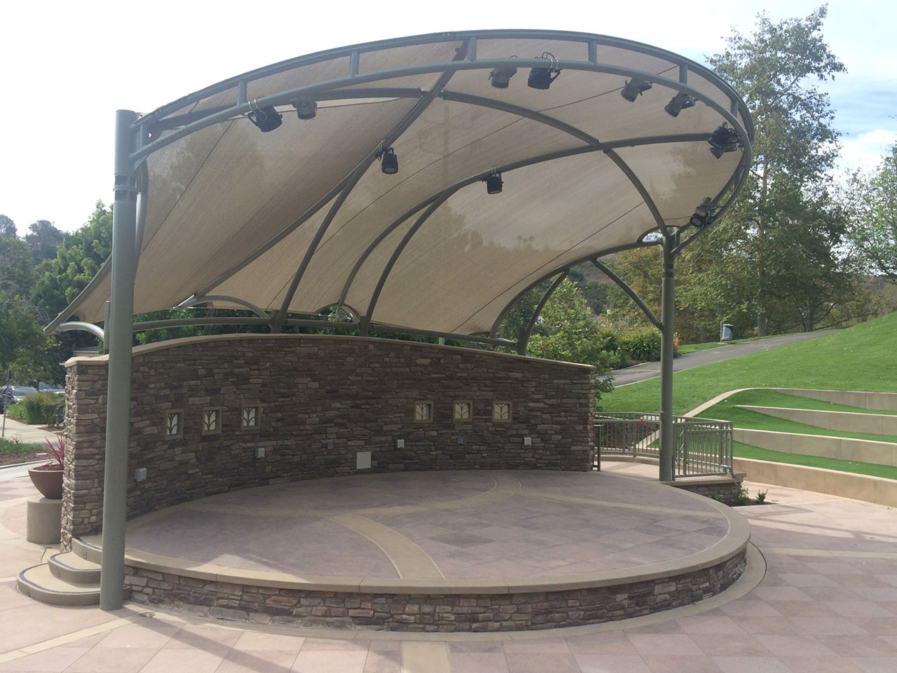 outdoor stage with tan shade covering