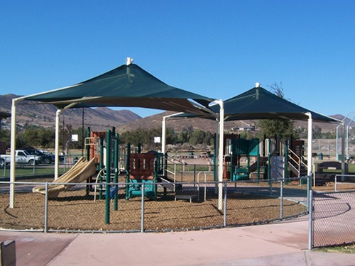 two playgrounds covering by green shades