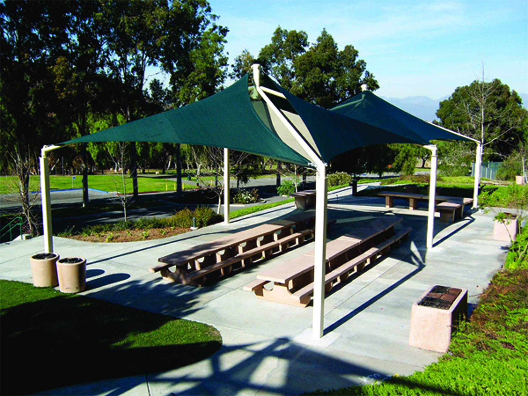 park picnic tables underneath green usa shade