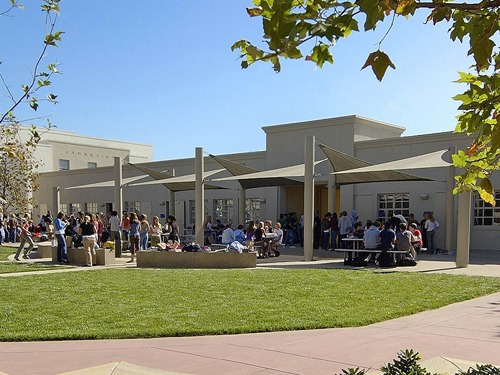 people sitting at outdoor seating outside of school