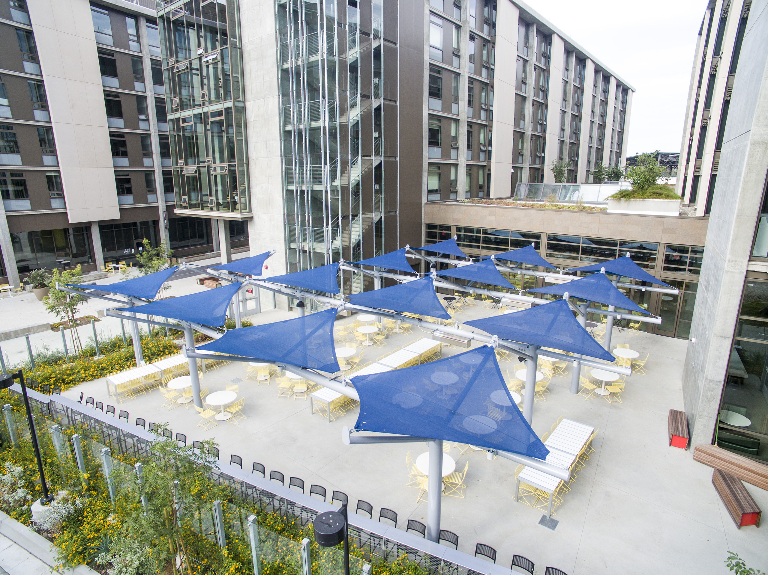 multiple blue sun shades covering outdoor dining area