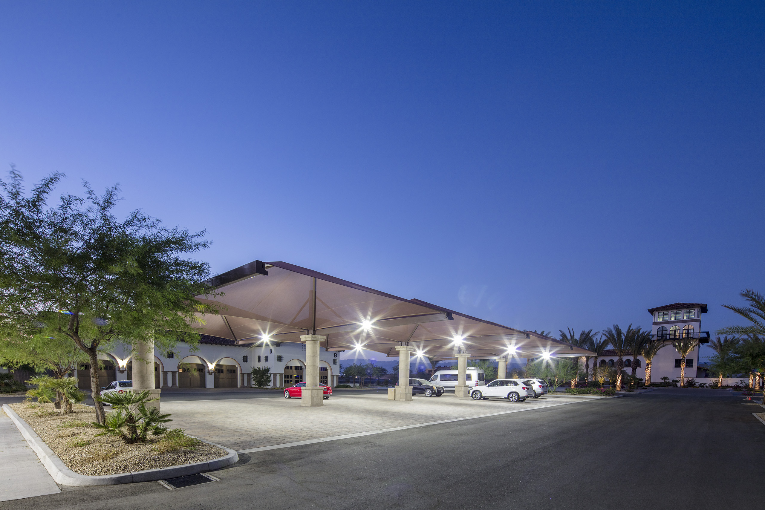 parked vehicles underneath terracotta sun shades