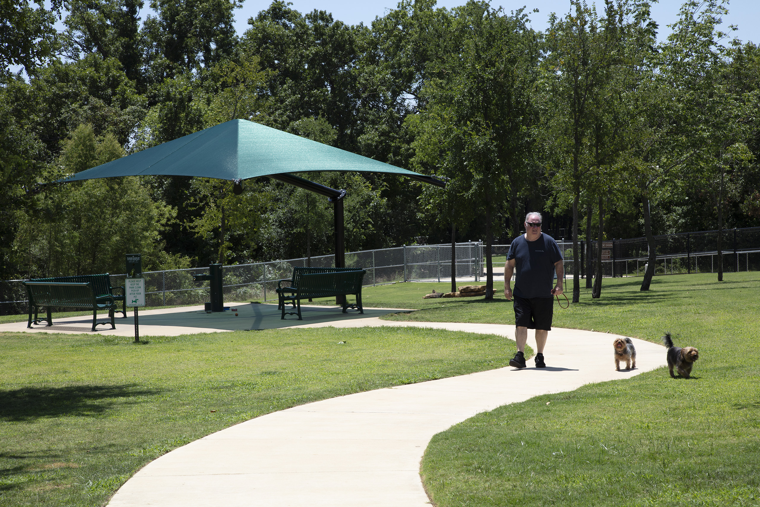 man walking dog through park
