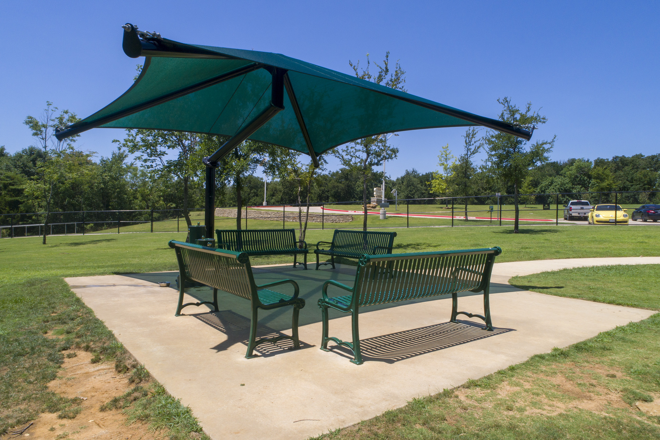 multiple benches shaded by usa shade in park