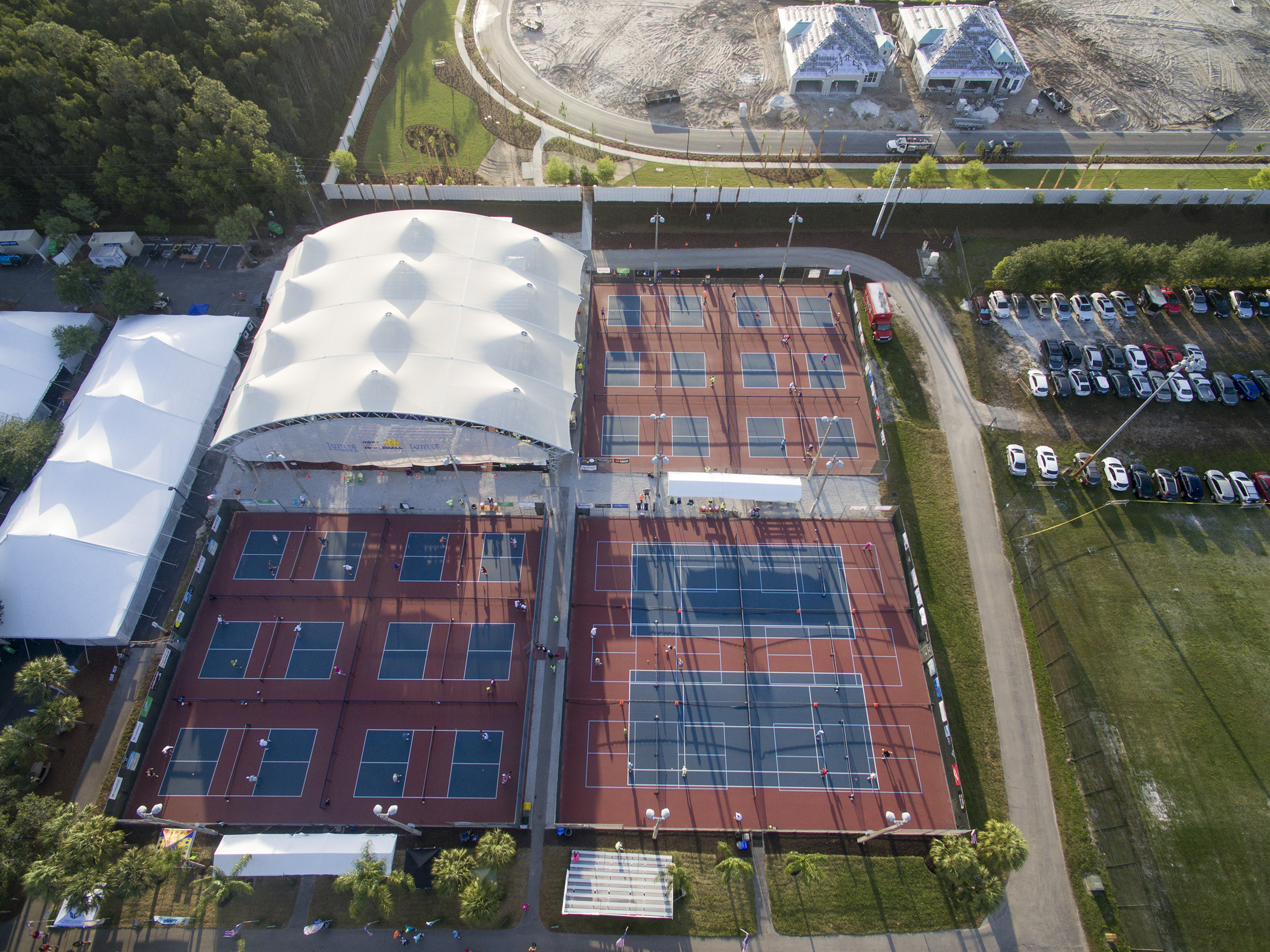 pickleball arena with multiple courts covered with usa shade