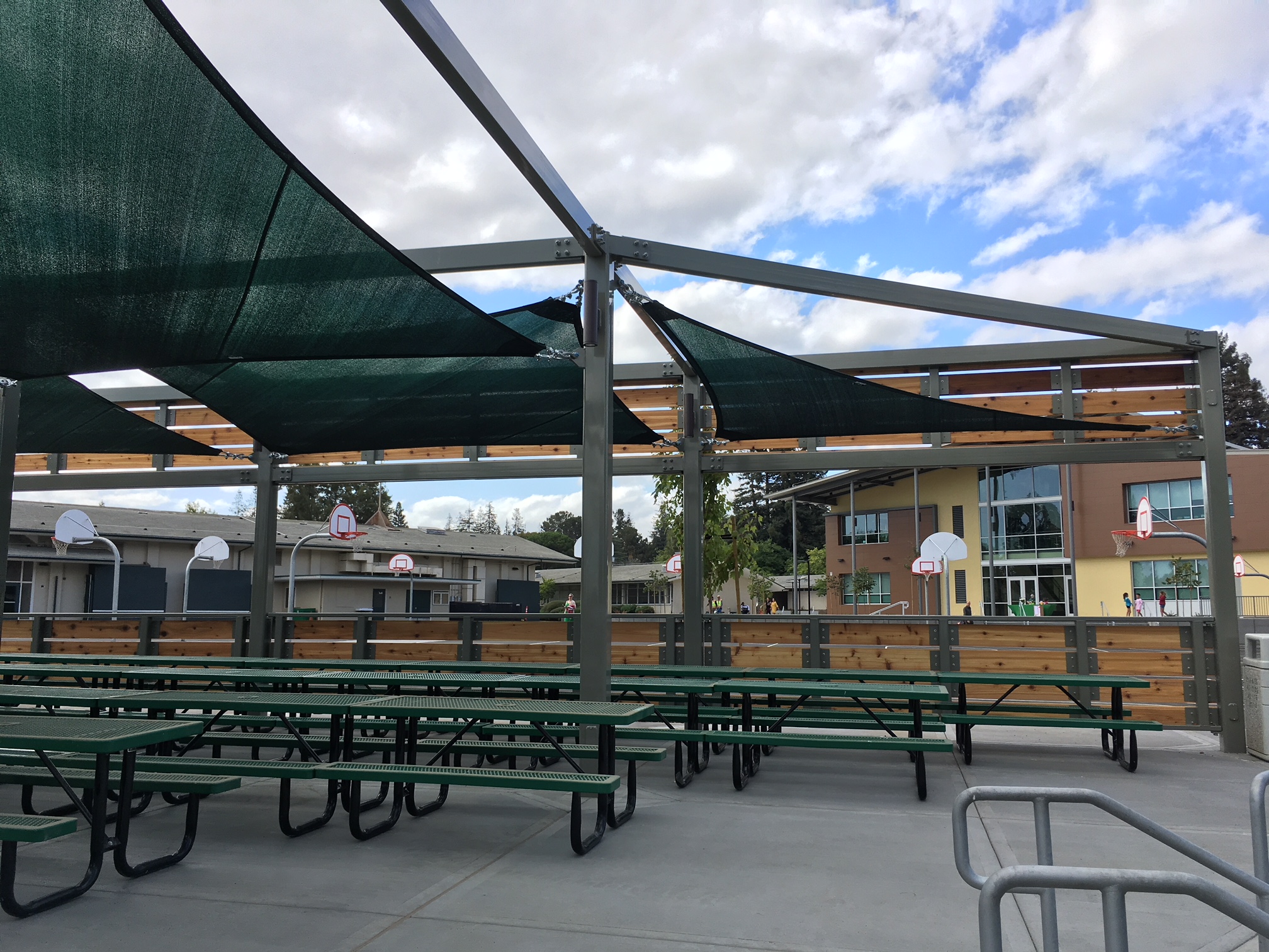 outdoor tables next to multiple basketball hoops