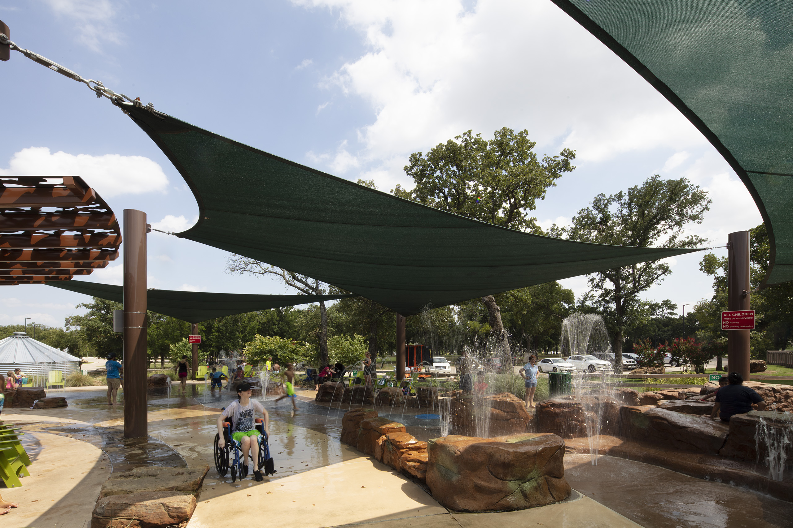 kids enjoying splashpad outdoors on sunny day