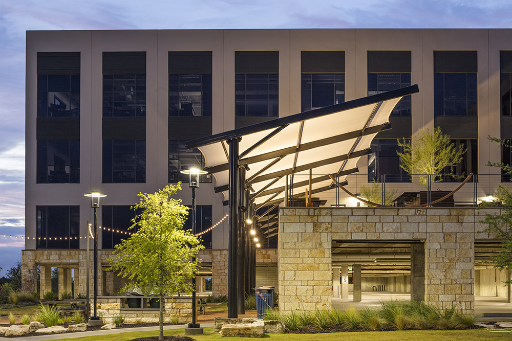 lighted outdoor space outside of tan building