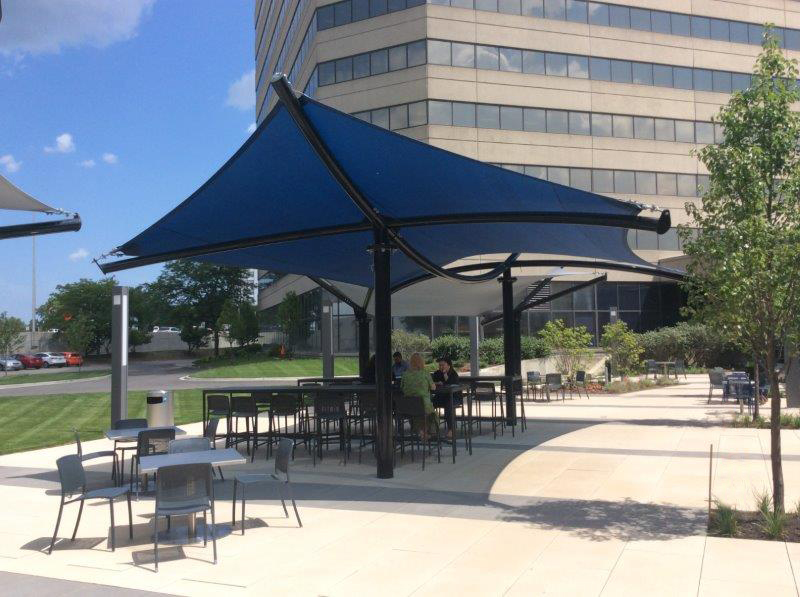 blue sun shade covering outdoor tables