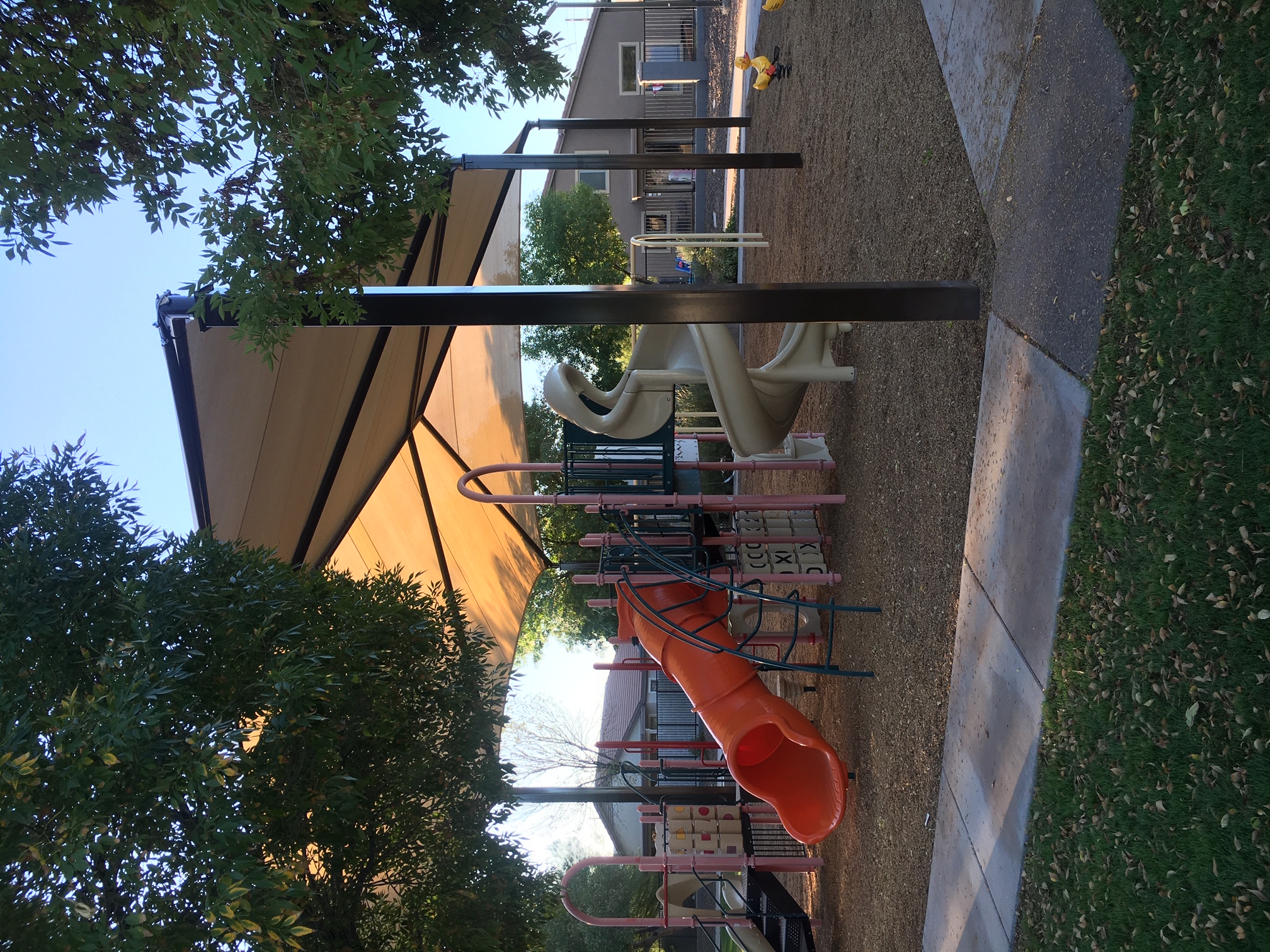 outdoor playground covered by tan usa shade