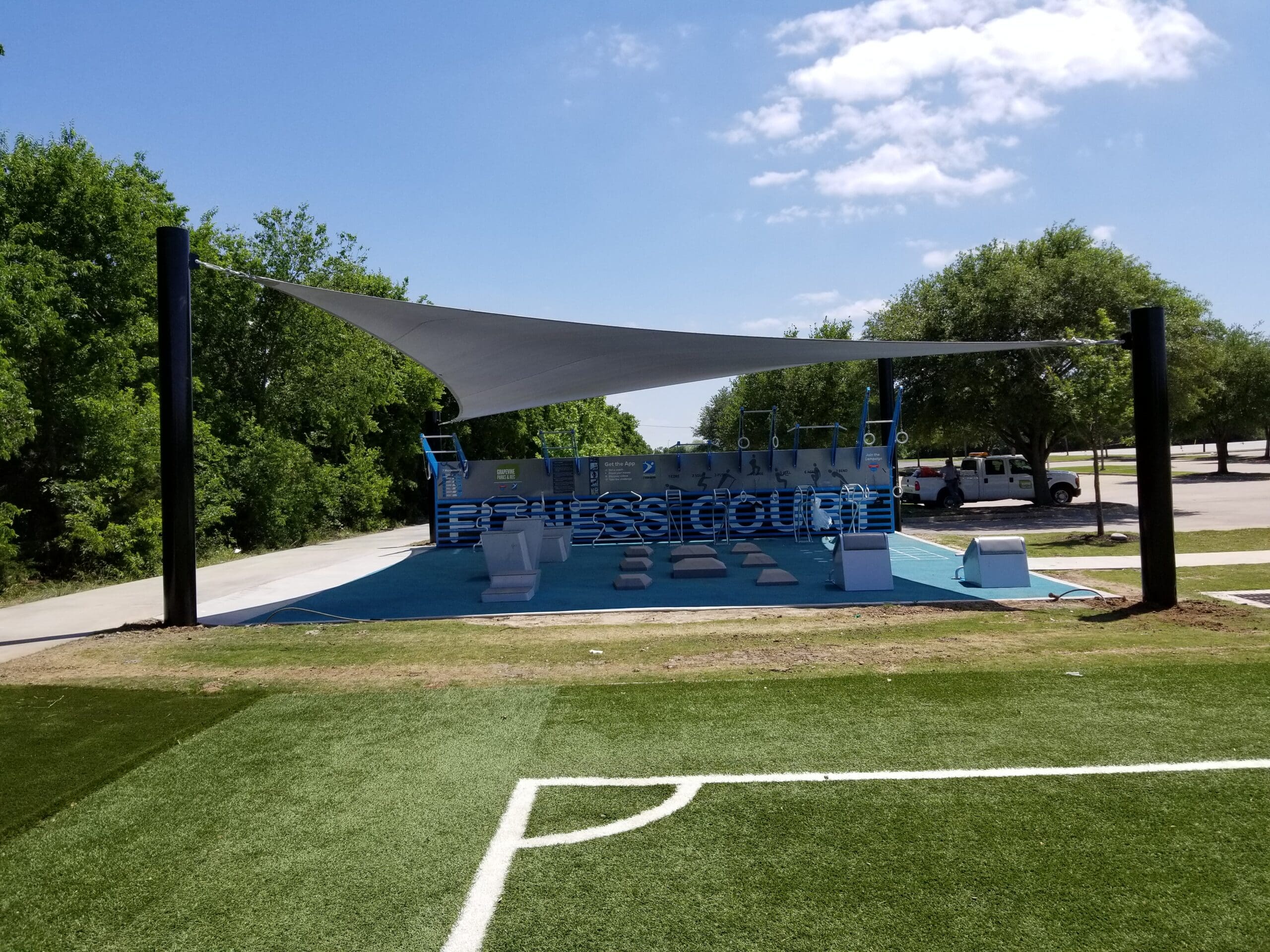 outdoor fitness area covered by triangle sun shade