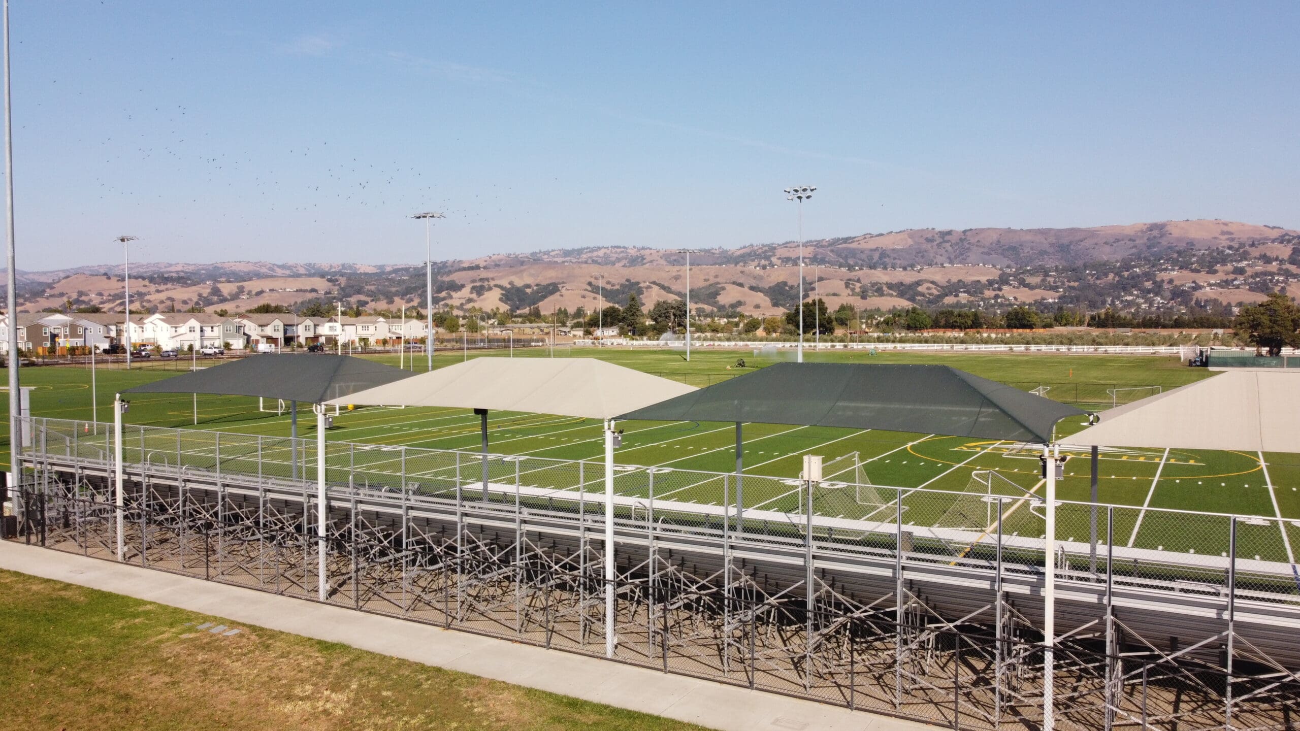 Fabric shade structures protecting bleachers at Morgan Hill Sports Center