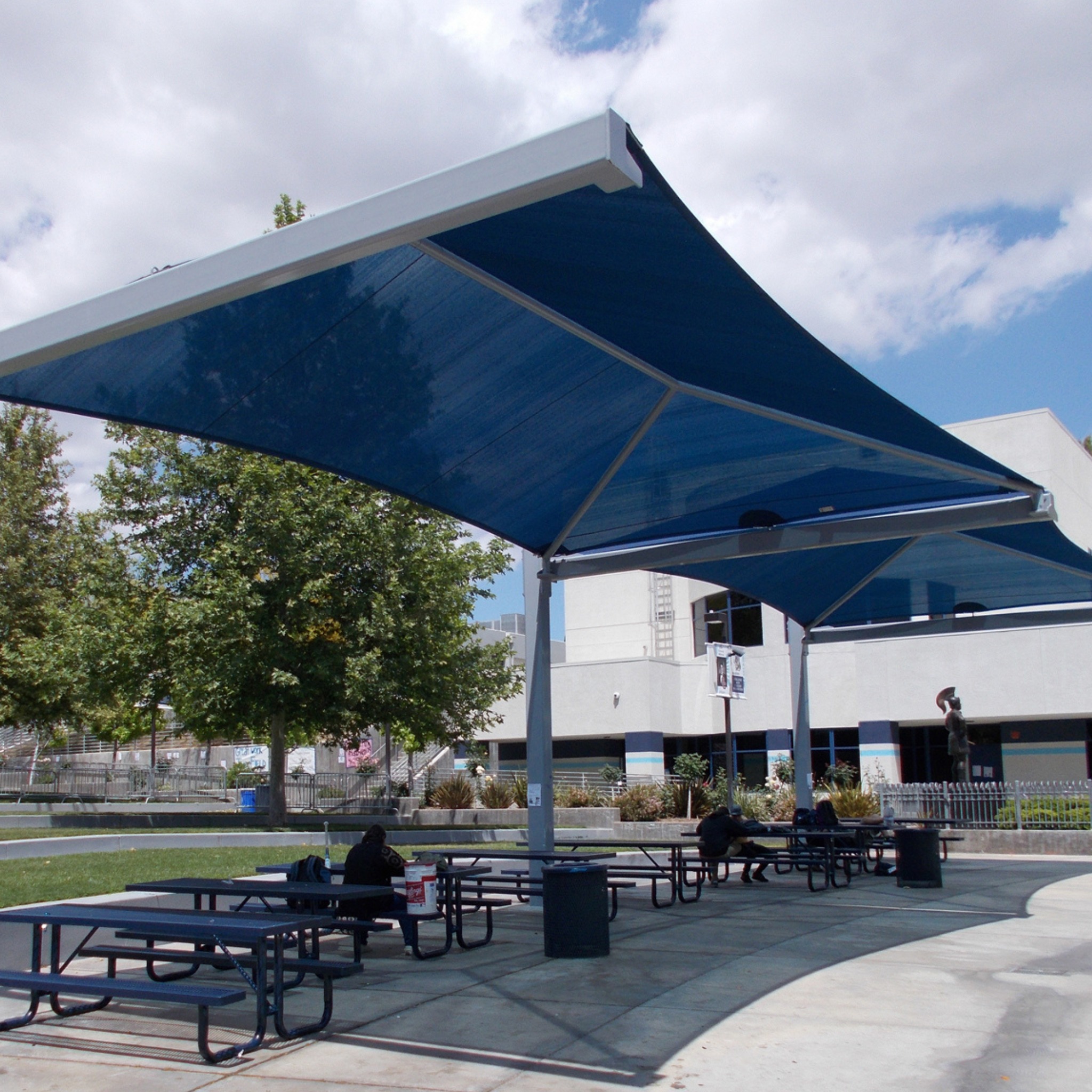 picnic tables shaded by large cantilevered sun shade