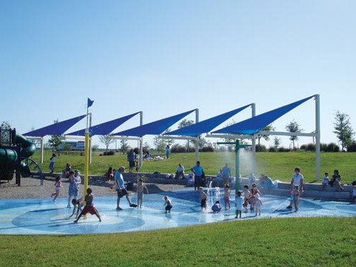 multiple triangle shade structures at outdoor splash pad