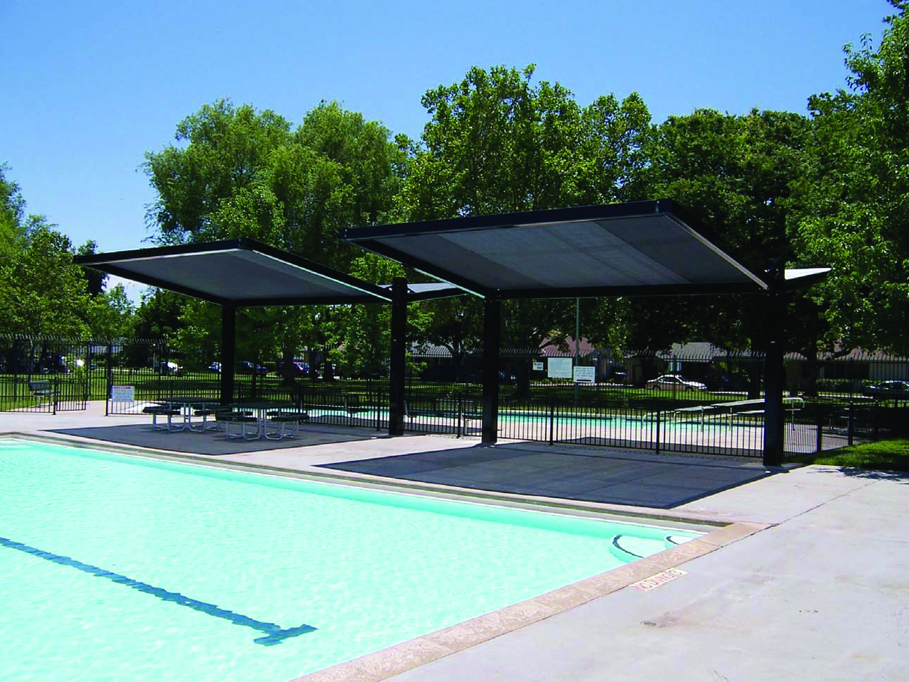 multiple usa shades covering seating at outdoor pool