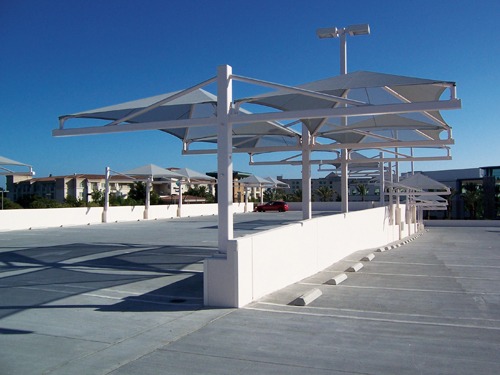 white umbrella shades covering parking lot