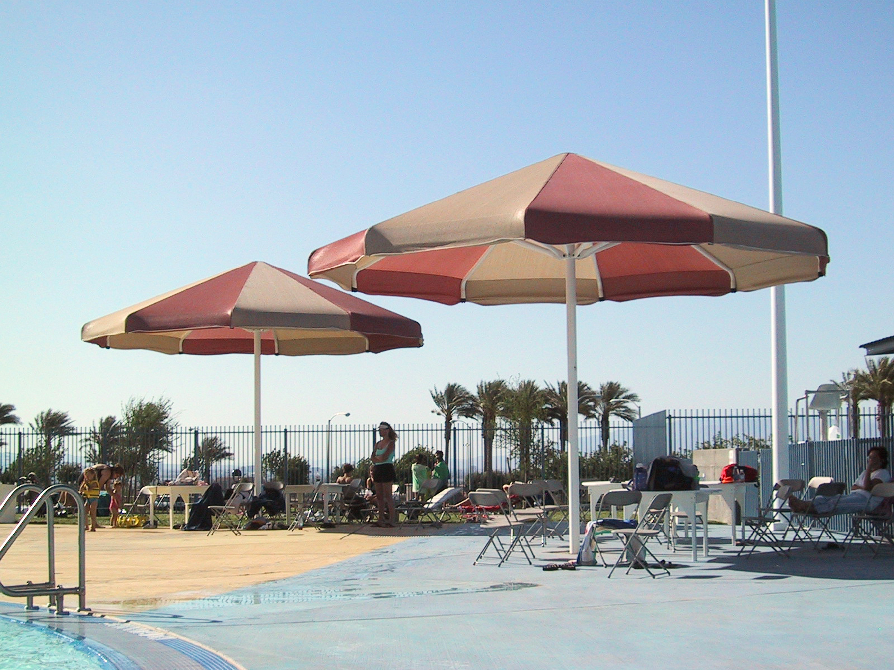 shades covering seating area next to pool