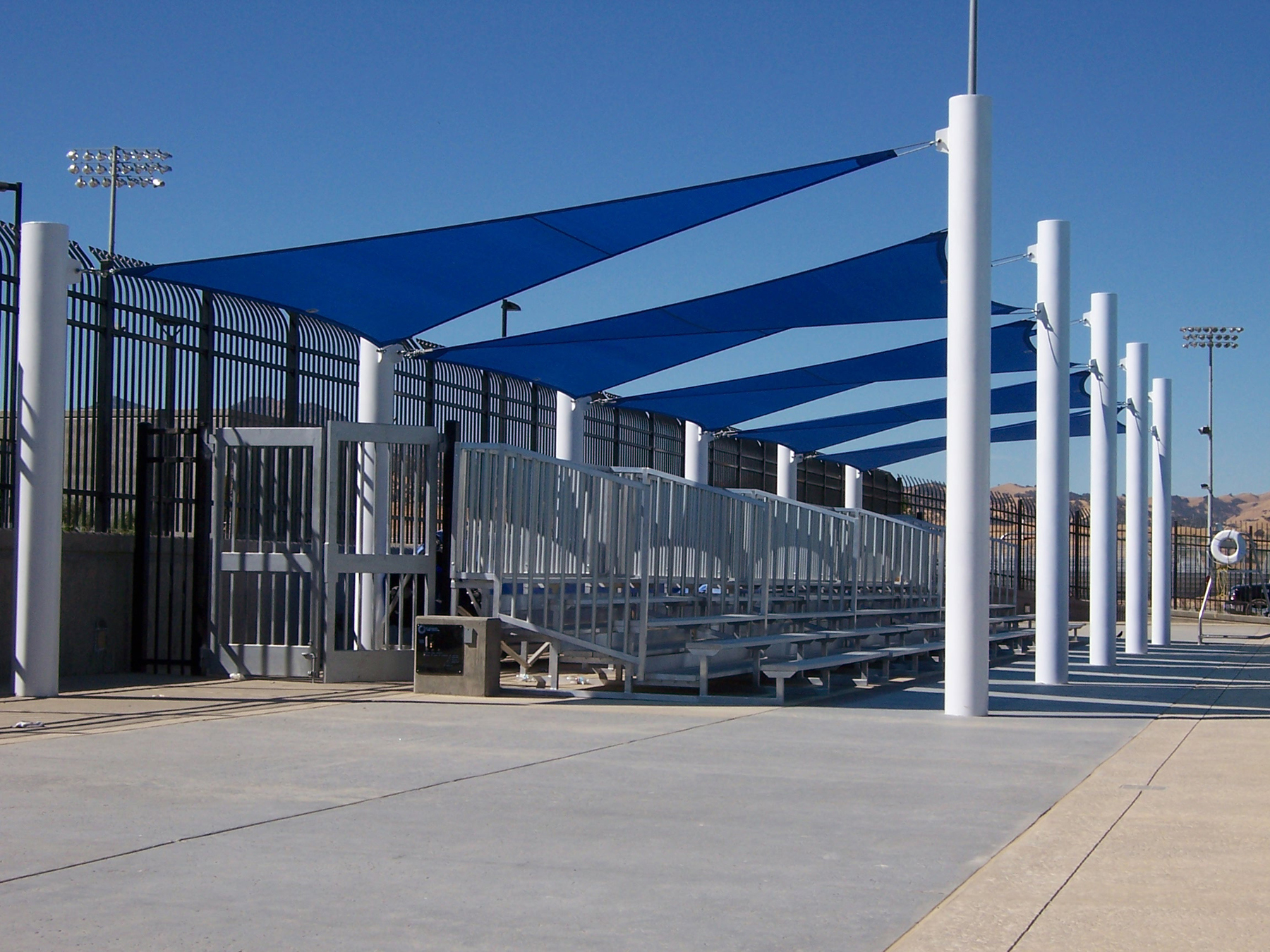 blue shades covering outdoor bleachers