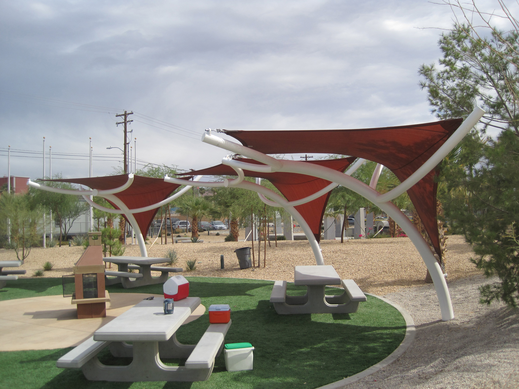triangle shades covering picnic tables