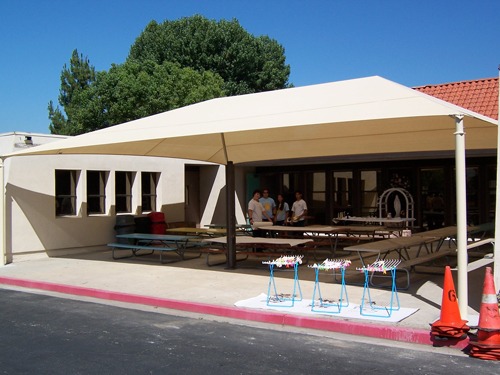 white usa shade covering picnic tables outside