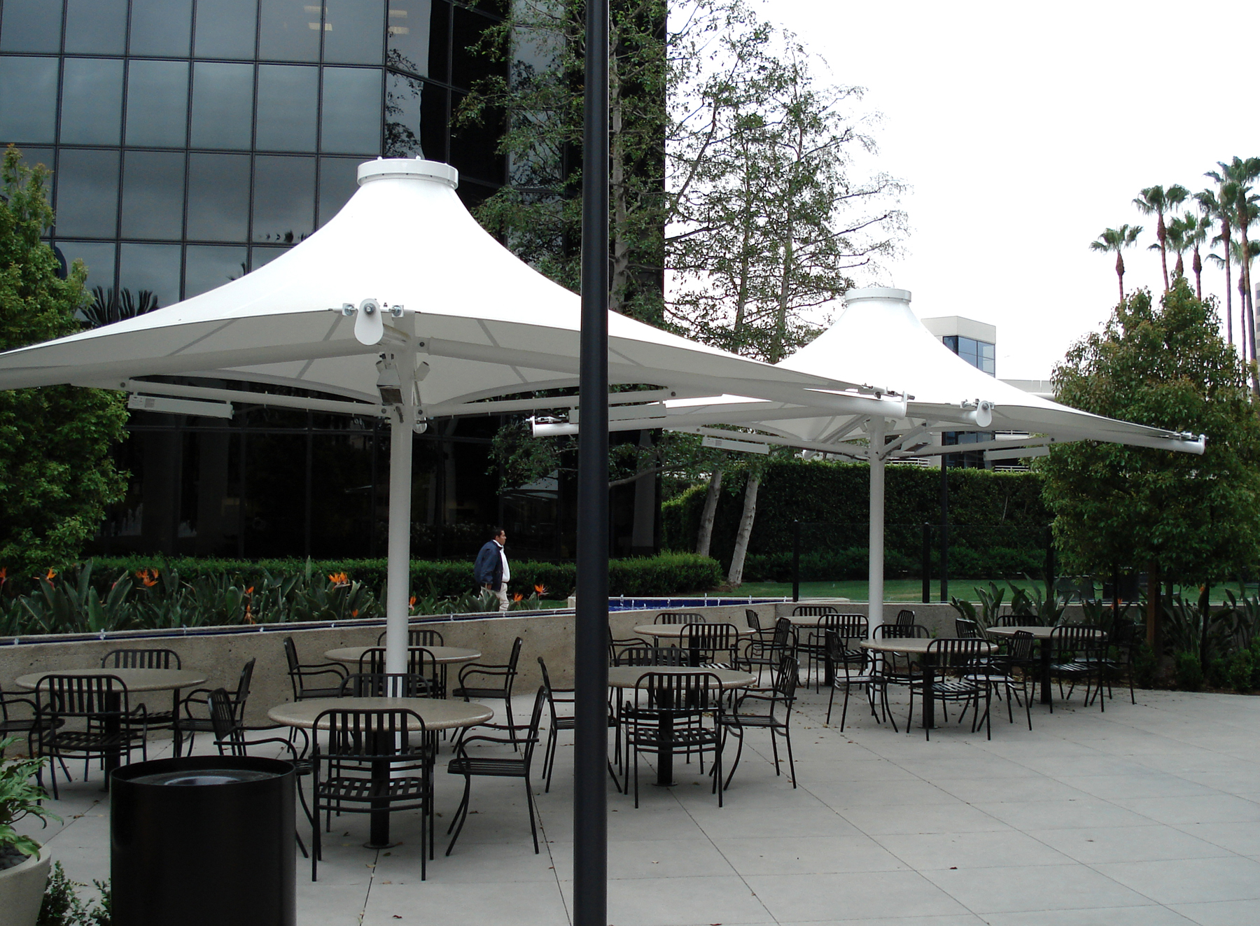 white umbrella shades covering tables