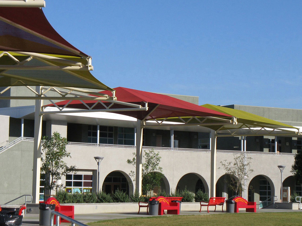 multiple sun shades outside grey building