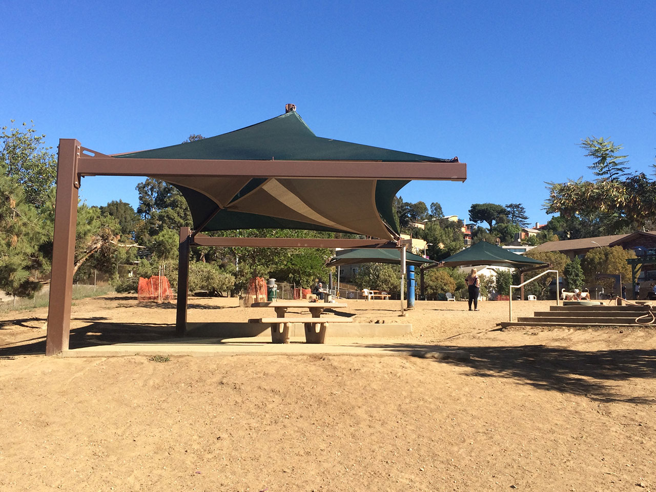 outdoor picnic table at dog park covered by usa shade
