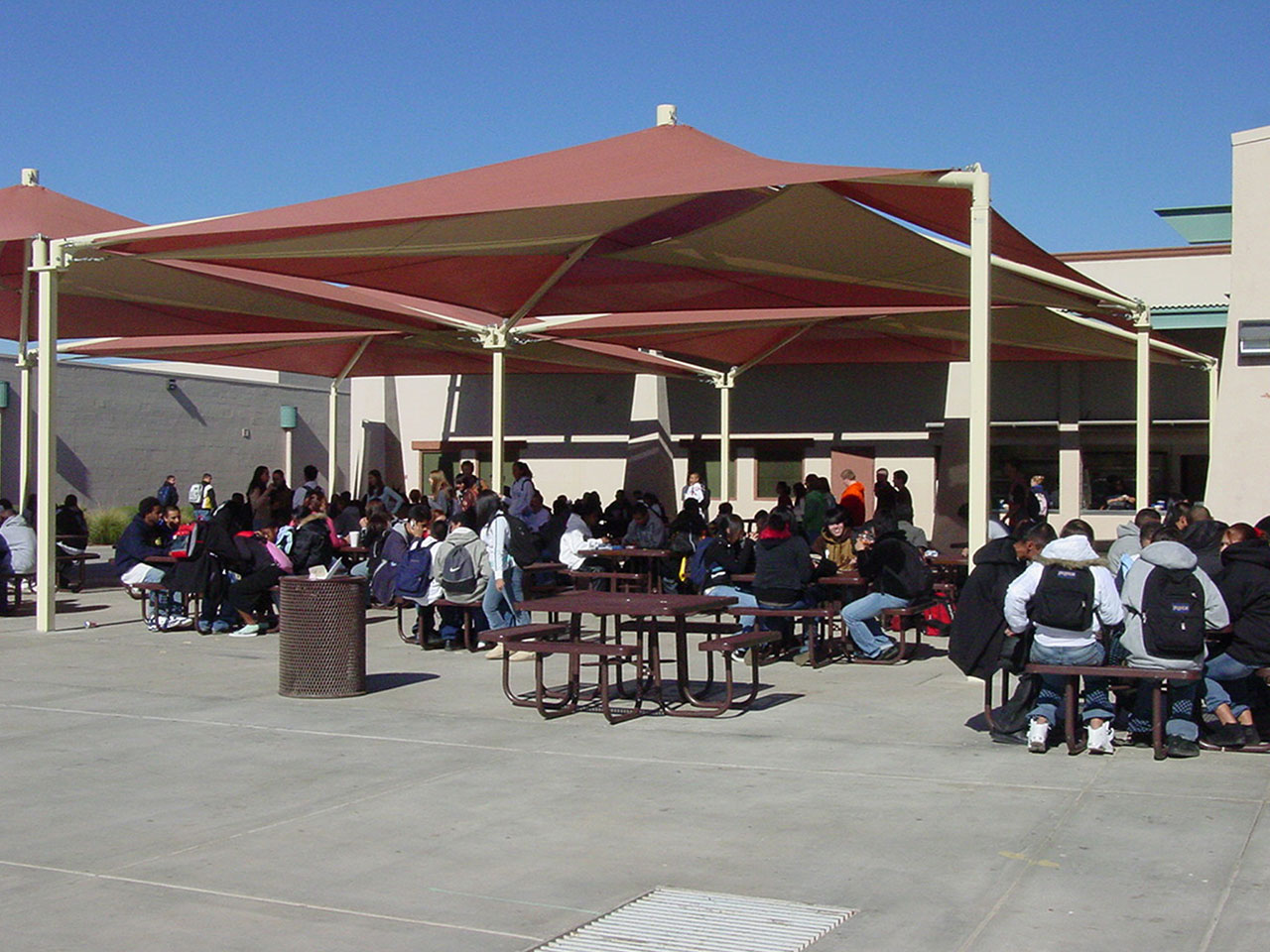 group of students sitting at outdoor picnic tables