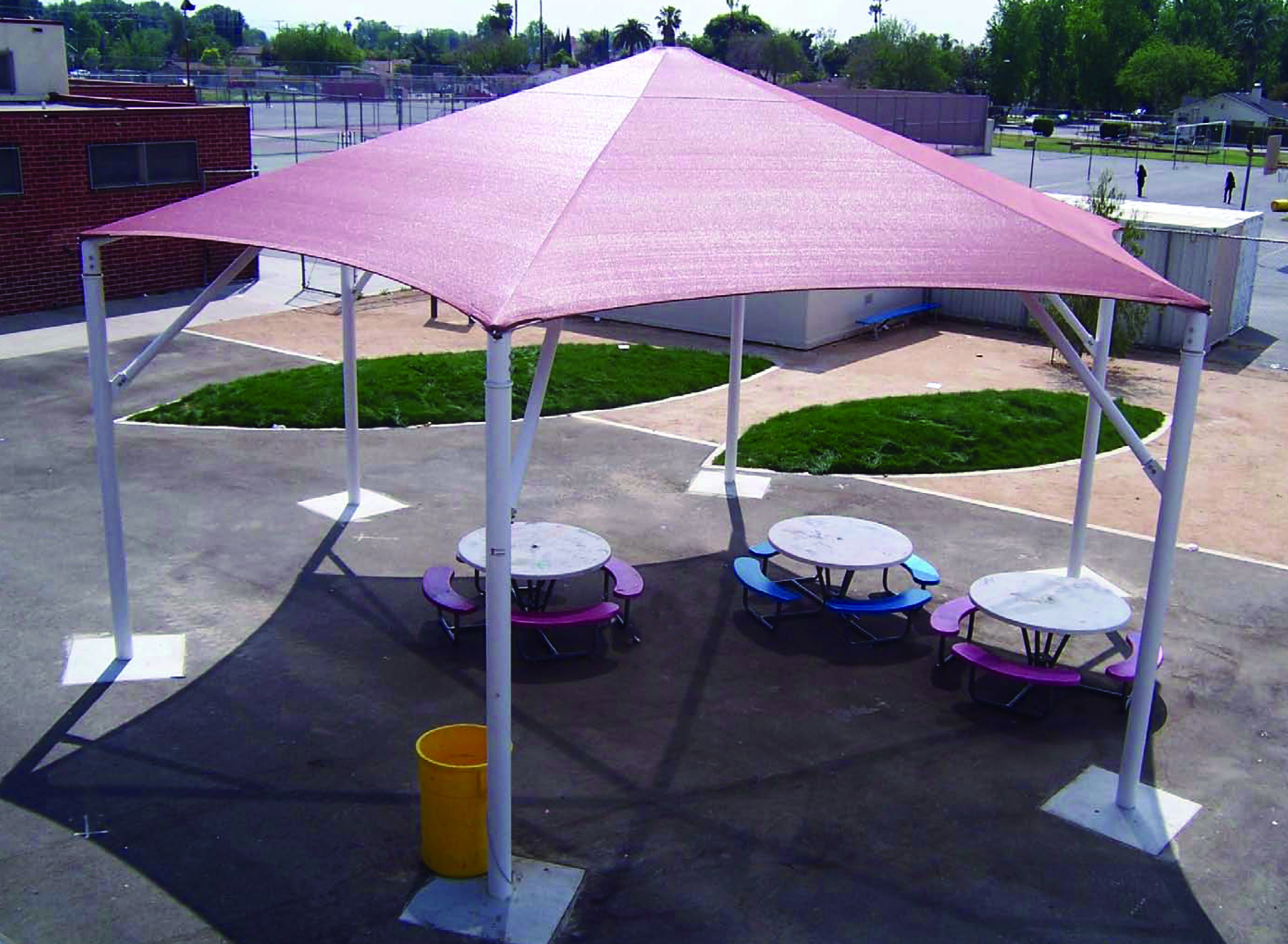 tall sunshade covering outdoor tables