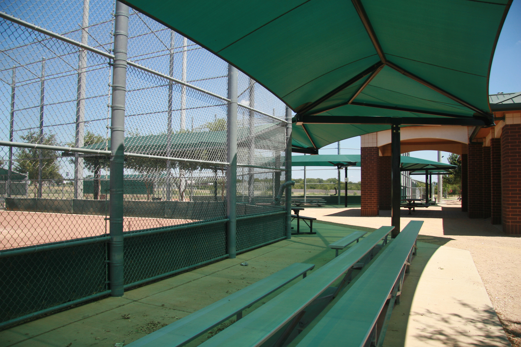 green shade covering metal bleachers