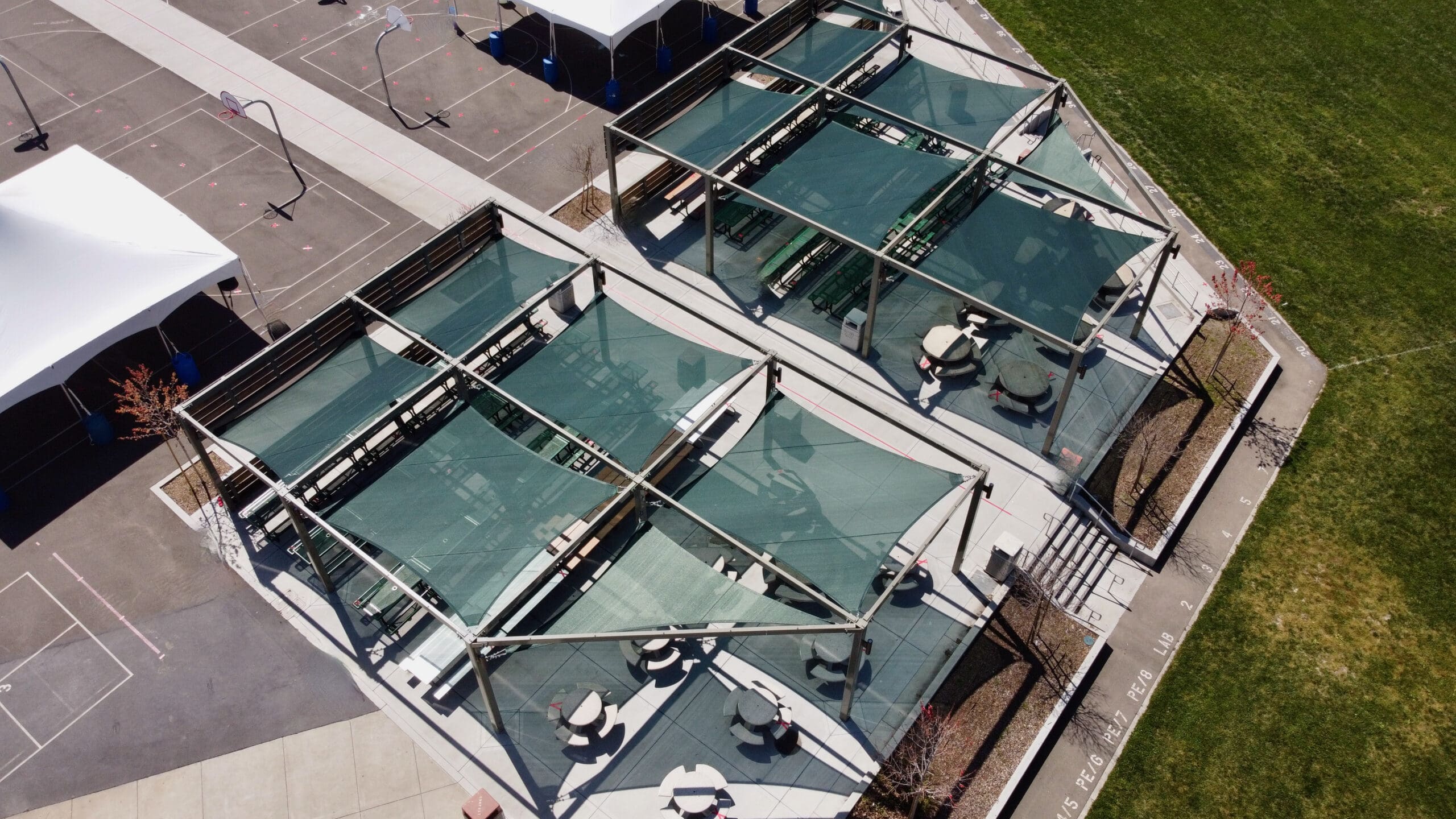 green shades covering outdoor picnic tables