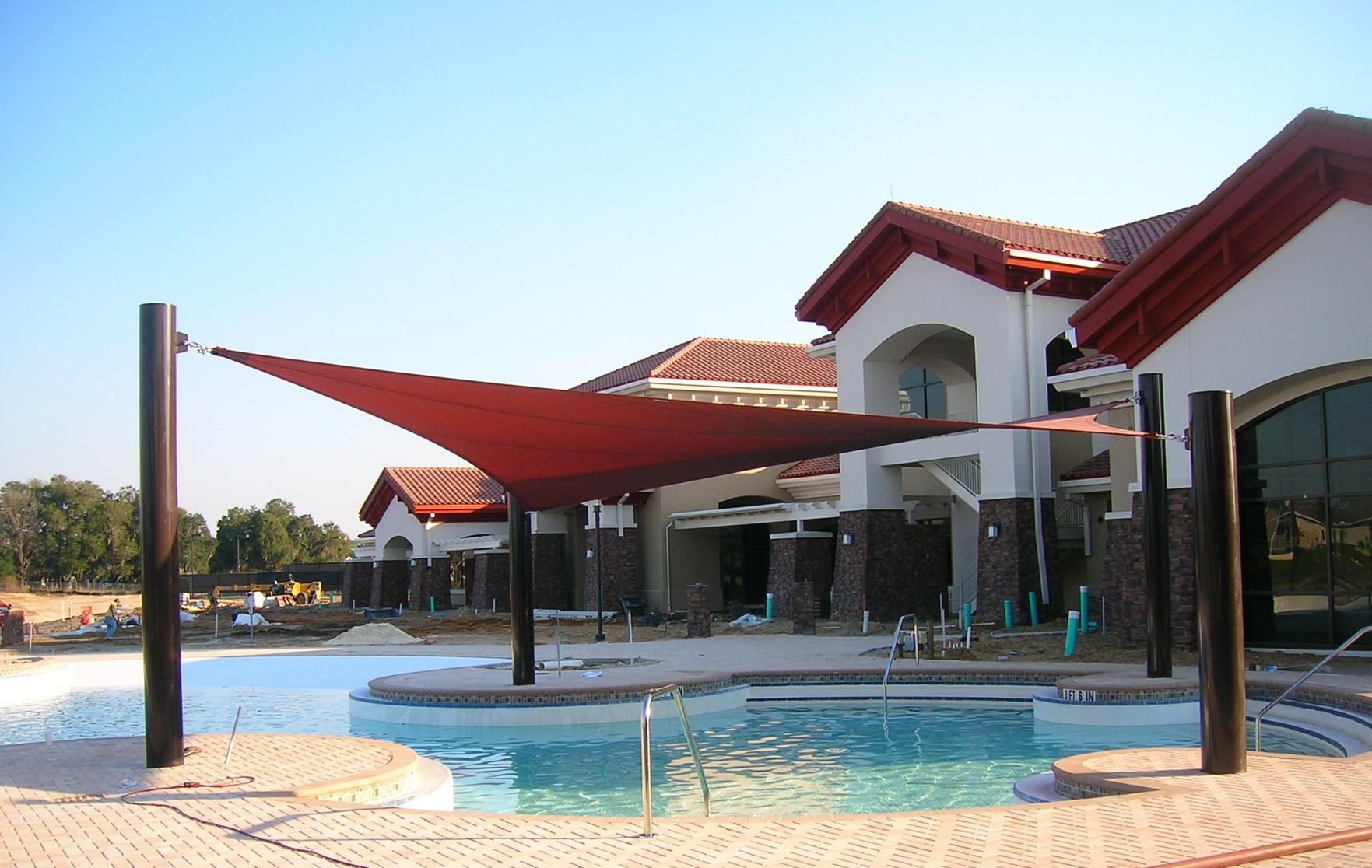 triangle shades next to outdoor pool