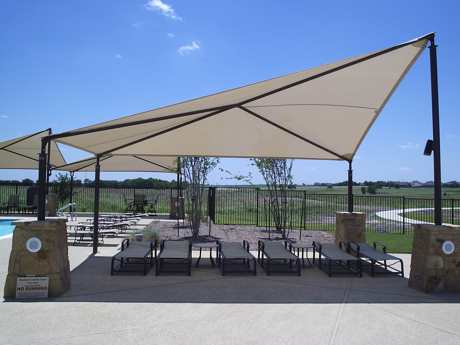 large sun shade covering lounge chairs