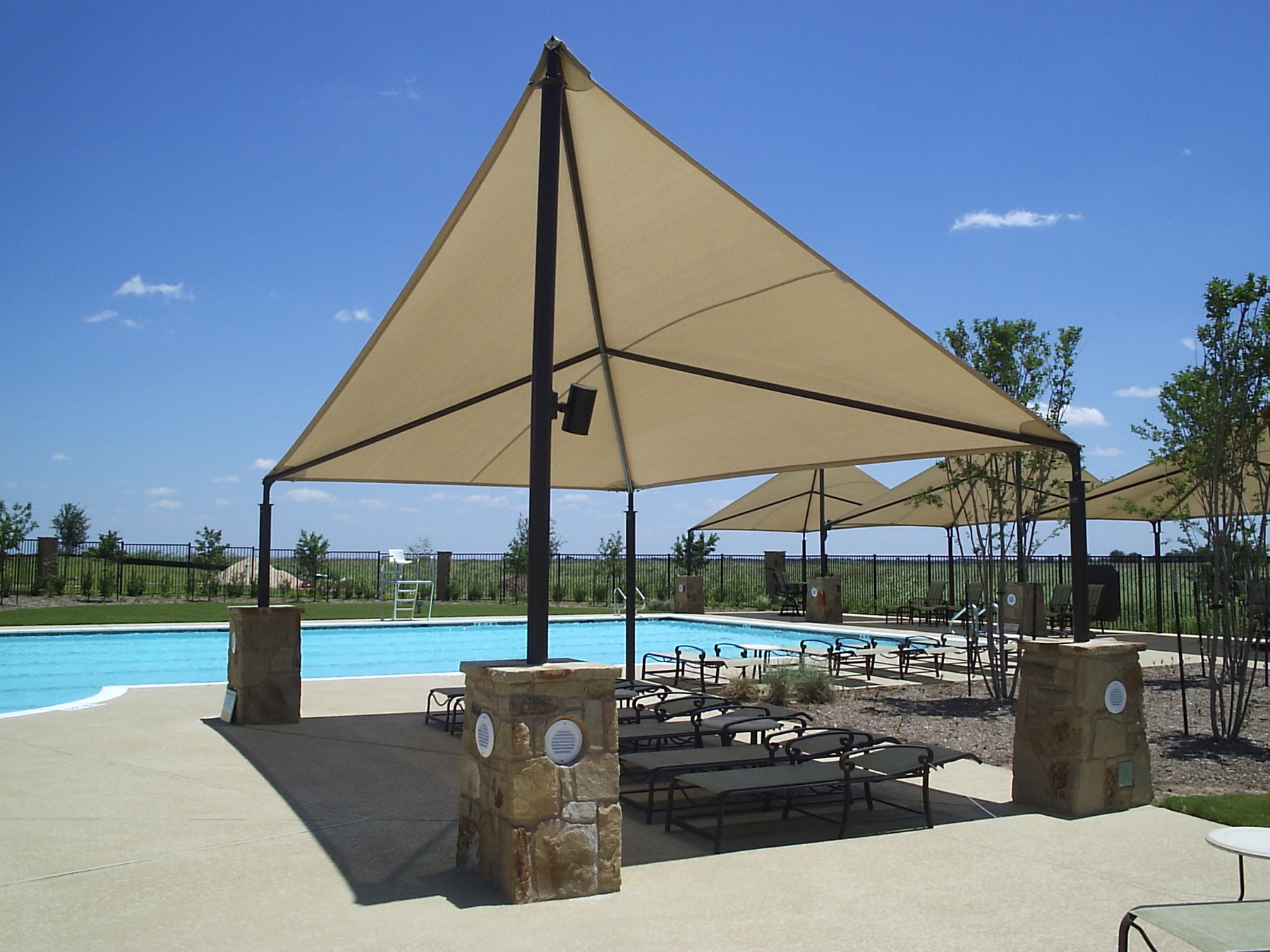 tan shade covering pool chairs