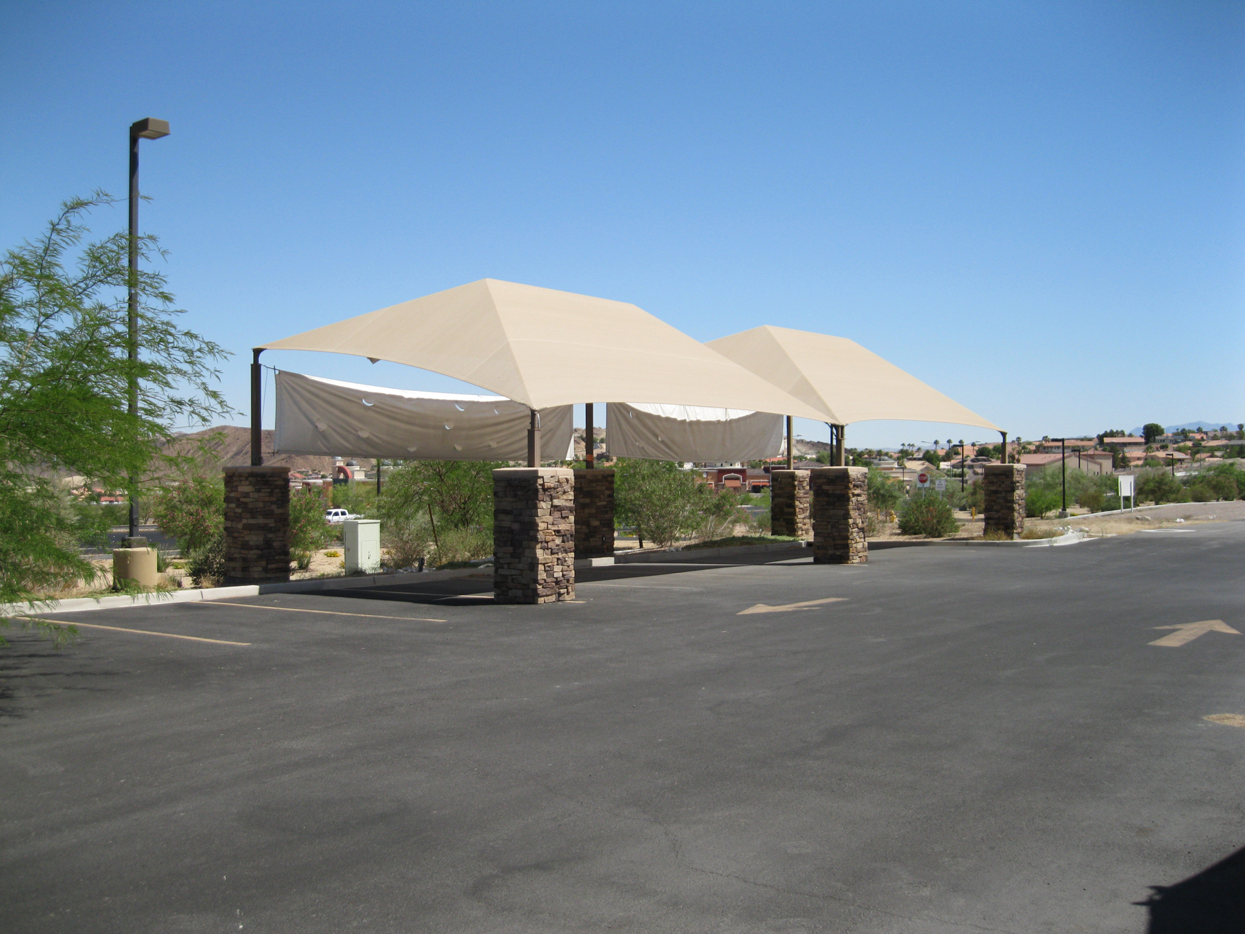 tan shade structure with rock pillars
