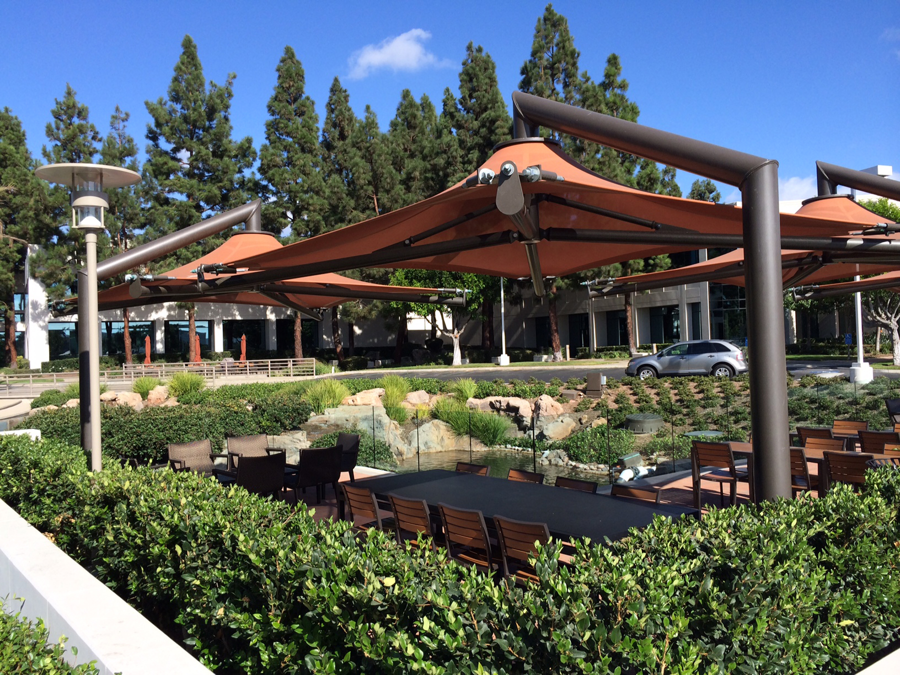 outdoor seating covered by orange umbrella shades