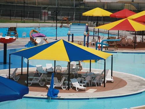multiple colorful usa shades set up at outdoor pool