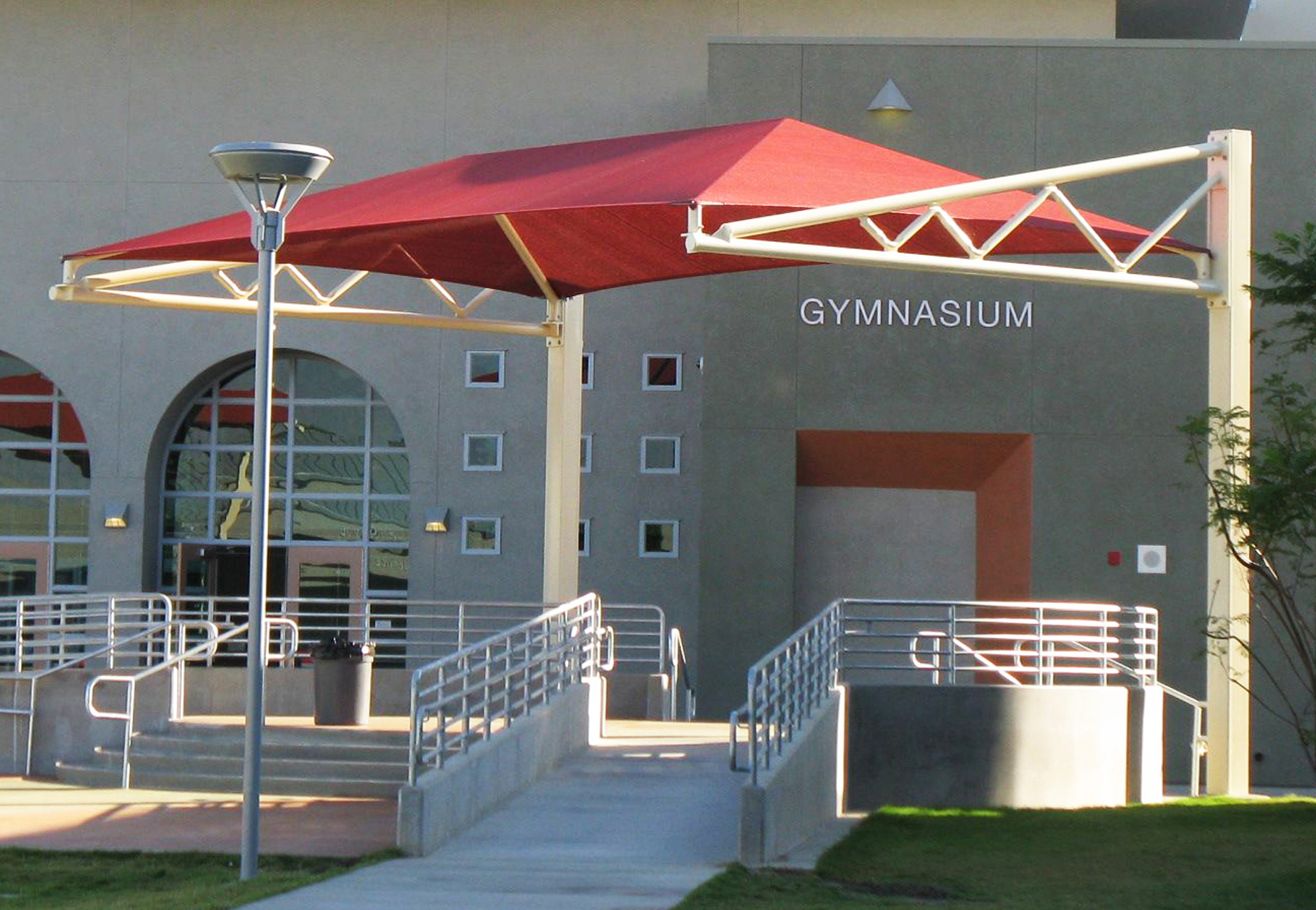 red sun shade outside gymnasium