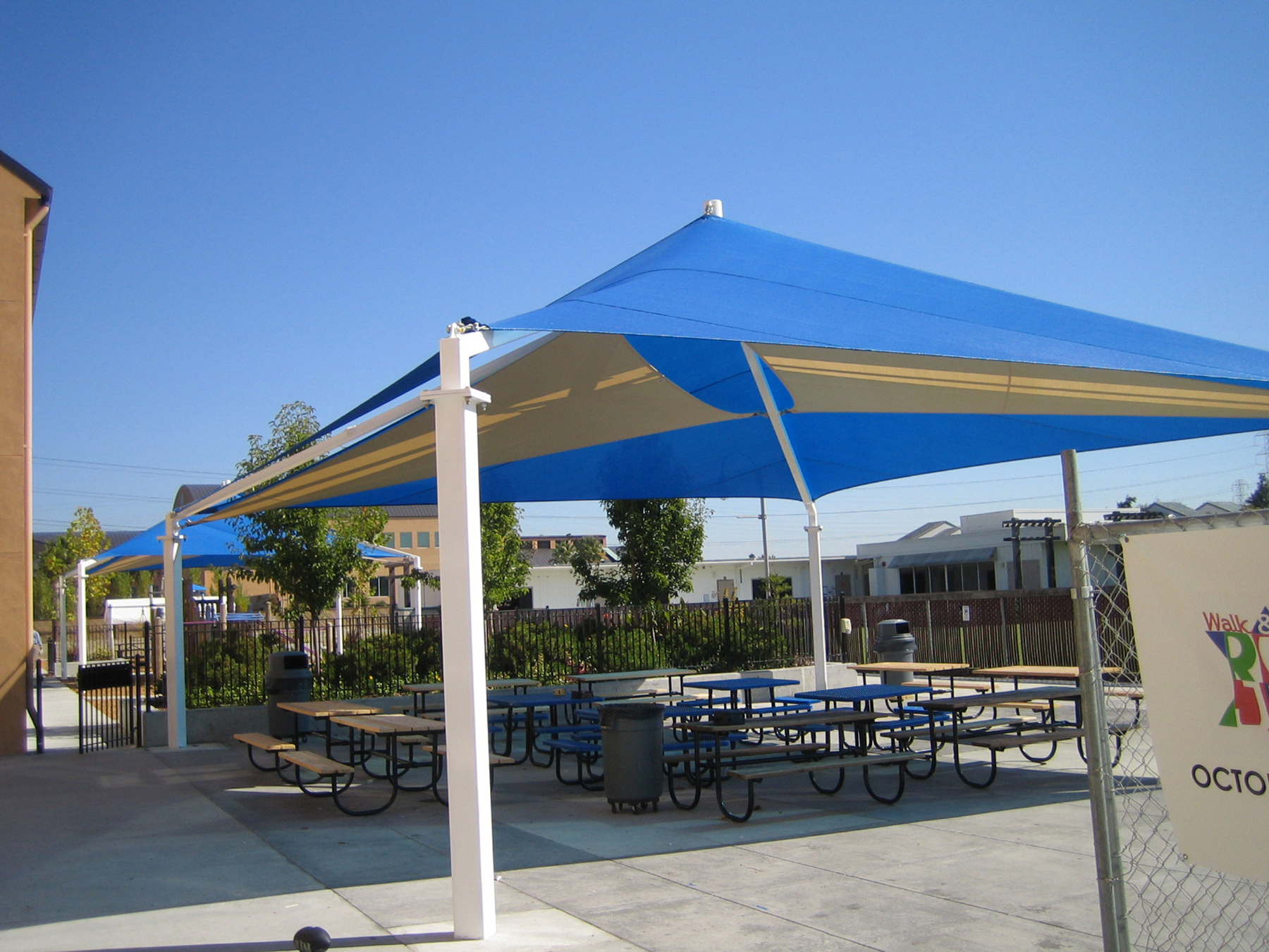 outdoor picnic tables covered by sun shade