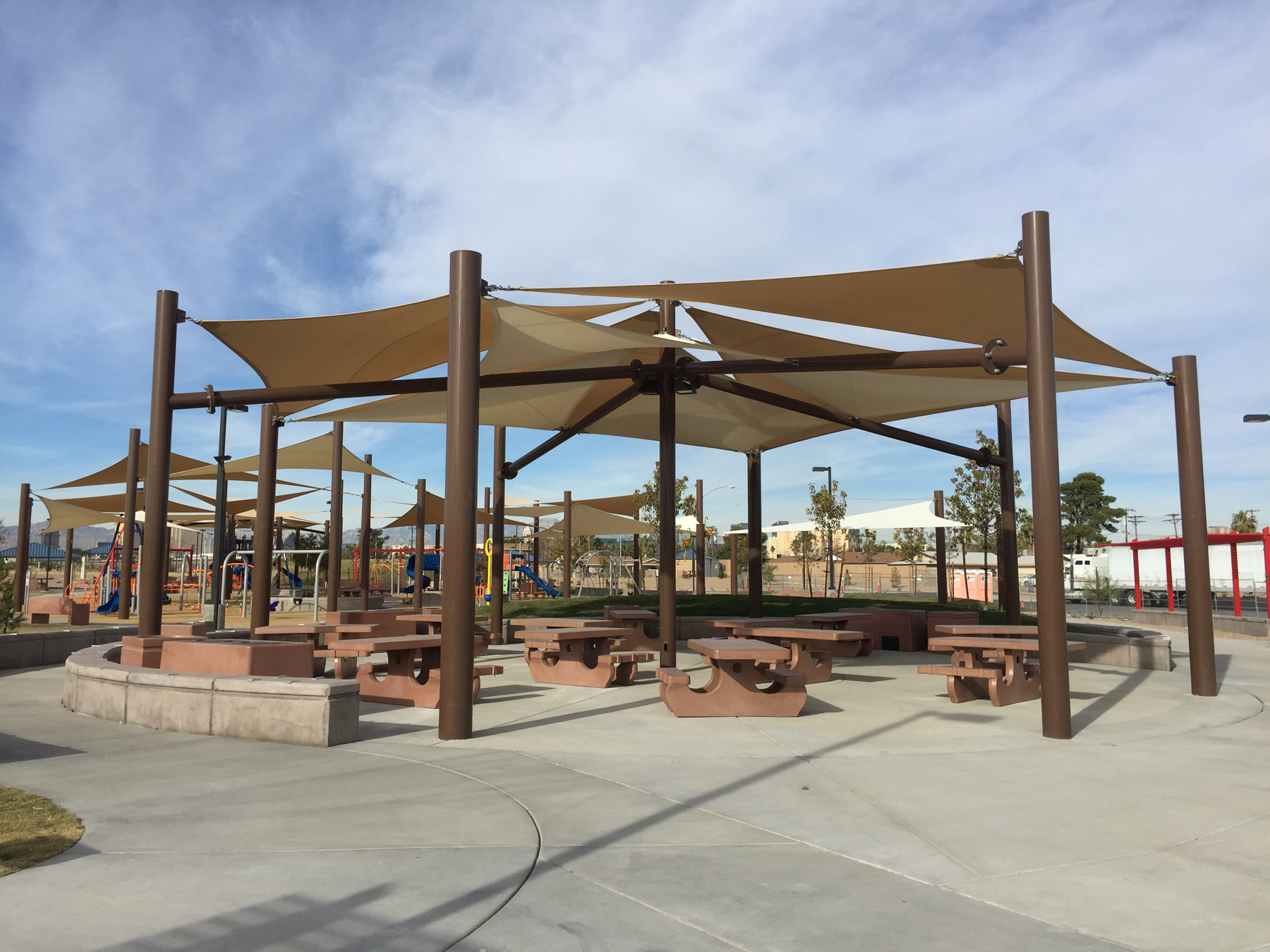 outdoor picnic tables covered by multiple usa shades