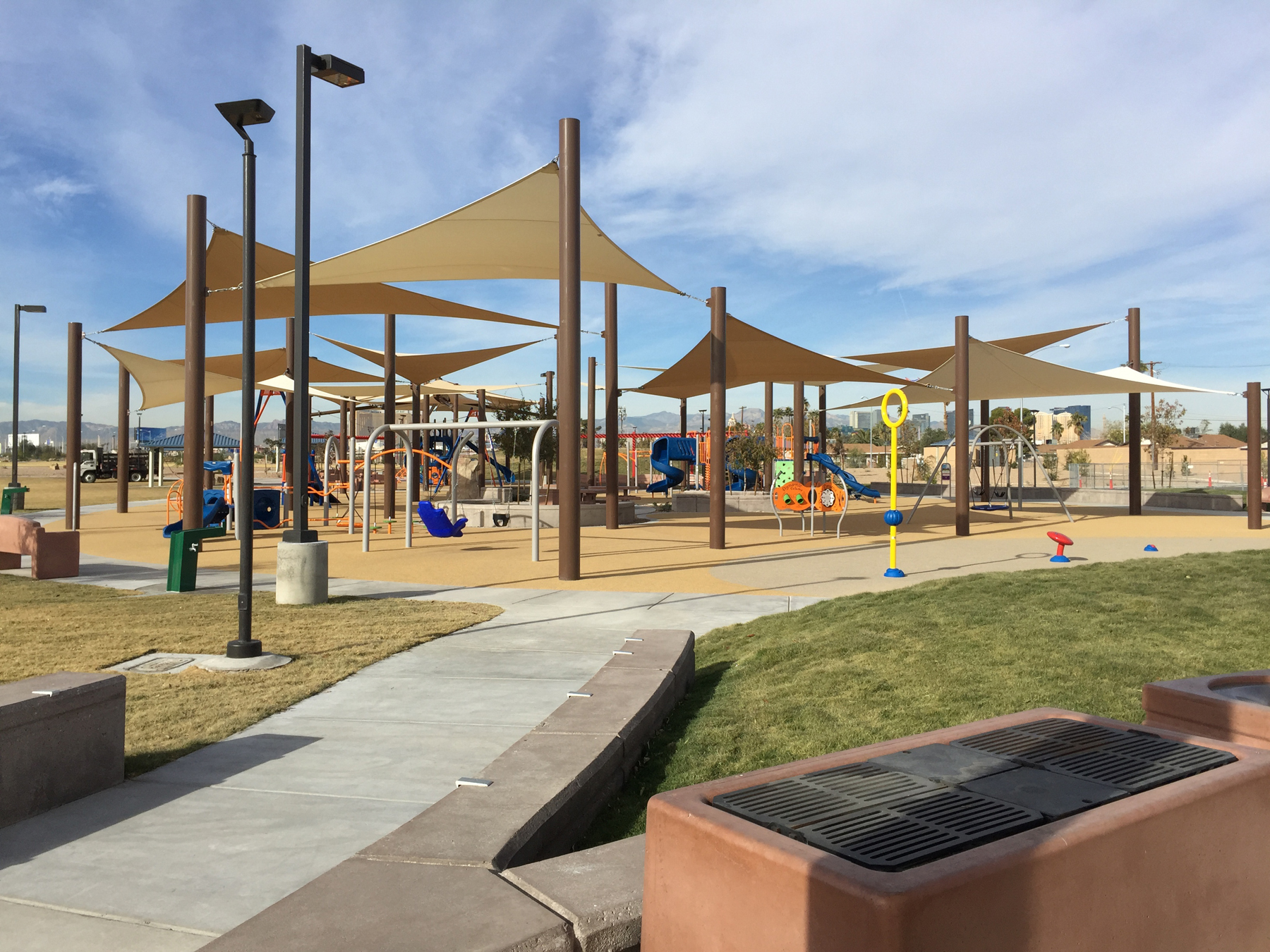 outdoor playground equipment under multiple usa shades