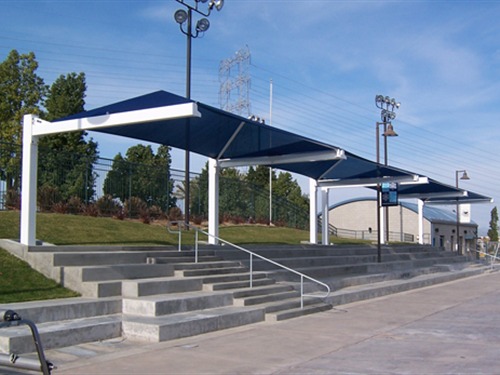 cantilever shade structure providing shade to stadium seats